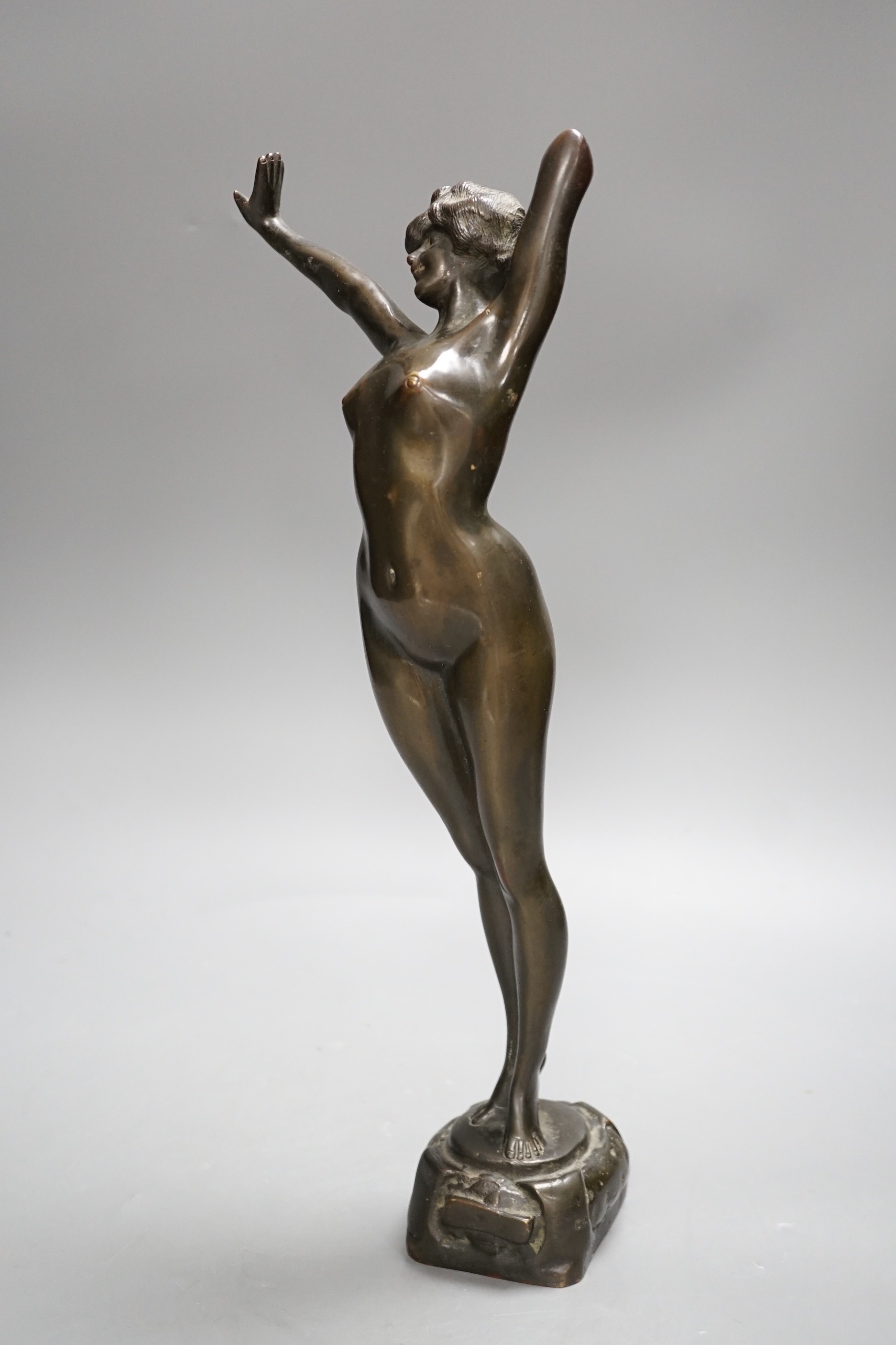 An Art Nouveau style female bronze nude. 39cms high.